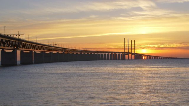 Oresundsbron at sunset. The bridge between Sweden and Denmark. Cars drive over the bridge