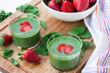 Green spinach smoothie with strawberry