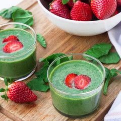 Green spinach smoothie with strawberry