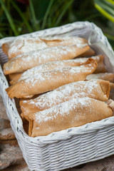 baking of unleavened dough with sweet filling, sprinkled with powdered, lined in a wicker basket