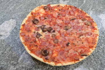 Pizza mit Schinken, Pilzen und Tomaten