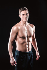 Fototapeta premium Fitness boy on black background