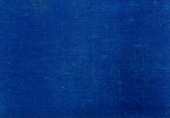 Grungy blue textile surface with scratches.
