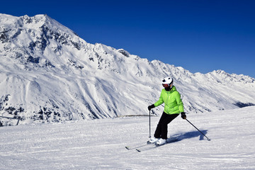 young woman is enjoying winter sports in Austrian Alps