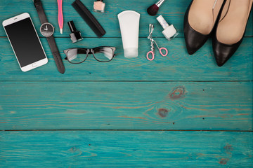 Travel concept - set of woman stuff on blue wooden background