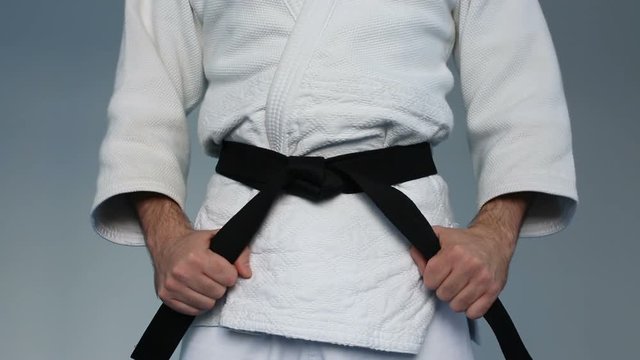 Martial arts Master tightening black belt