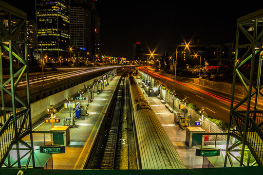 A scene night of the train station, railway, and highway in Tel Aviv, Israe
