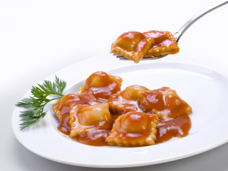 Ravioli dish and a fork over two raviolis