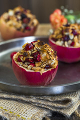 Festive baked red apples stuffed with granola, cranberries and marzipan