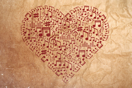 Heart collected from musical notes on brown background