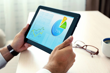 Businessman holding tablet-pc with scheme on screen