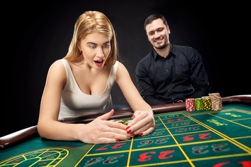 Couple playing roulette wins at the casino.