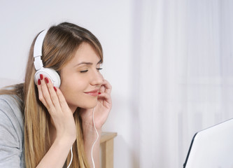 portrait of a young beautiful woman listening to music while rel