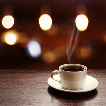 Cup of coffee on table on blured cafe background