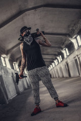 Fototapeta na wymiar A man in a mask holds gun and skateboard.