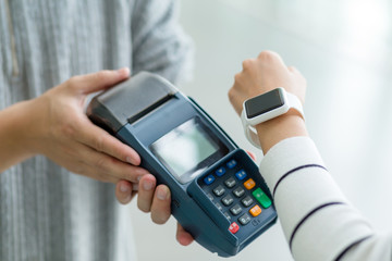 Woman using smart watch to pay