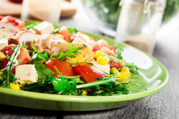 Fresh salad with chicken breast, arugula and tomato