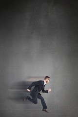 Fototapeta premium Composite image of geeky young businessman running mid air