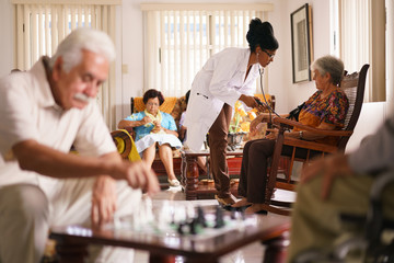 Hospice Doctor Measuring Blood Pressure To Senior Woman - obrazy, fototapety, plakaty