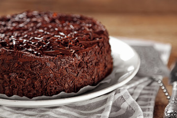 Tasty chocolate cake on wooden background