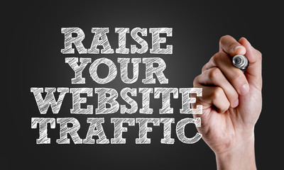 Hand writing the text: Raise Your Website Traffic