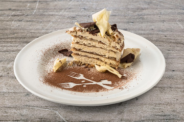 Tiramisu cake with white and dark chocolate flakes