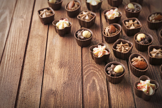 Chocolate sweets on wooden background