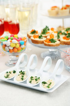 Set of cold snacks, canape, beverages and dessert, closeup