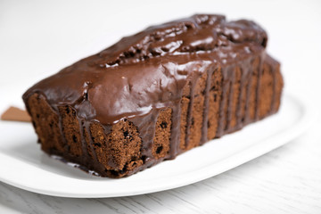 Chocolate cake with icing on white table