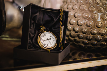 Black box with golden pocket watch
