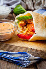 Fried chicken meat with vegetables in pita bread