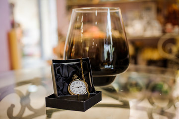 Black box with golden pocket watch