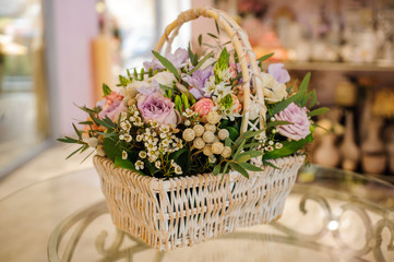 beautiful bouquet of mixed flowers in basket on table