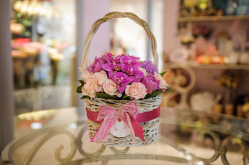 beautiful pink bouquet of mixed flowers in basket on table