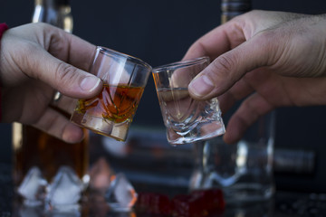 Ringing glasses, vodka and whiskey