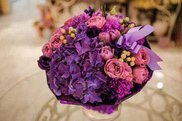 purple flower bouquet composition  on table