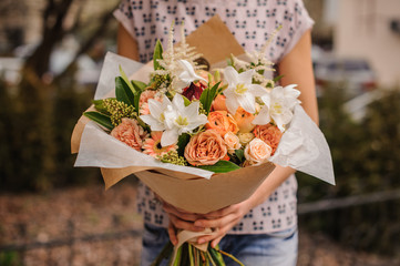 Bouquet of the different  orange flowers in hands