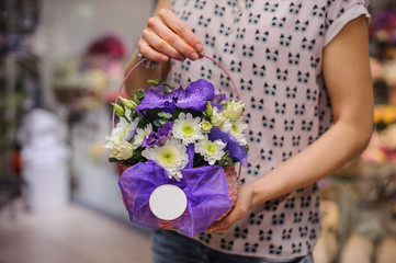 purple flower bouquet composition  in hands