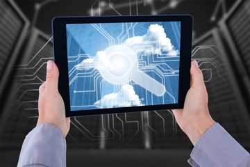 Composite image of cropped hand of man holding digital tablet