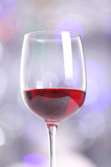 Wineglass on blurred lights background