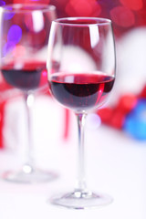 Wineglasses on red blurred lights background