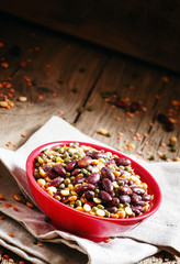 Bean mix: purple beans, green and red lentils, dry peas in a red