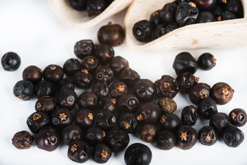 Wooden scoop with dried juniper berries