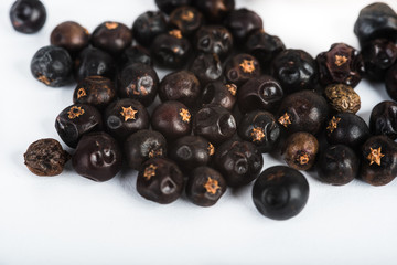 Wooden scoop with dried juniper berries