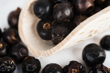 Wooden scoop with dried juniper berries