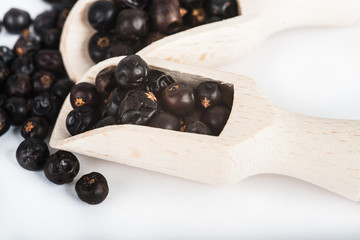 Wooden scoop with dried juniper berries