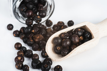 Wooden scoop with dried juniper berries