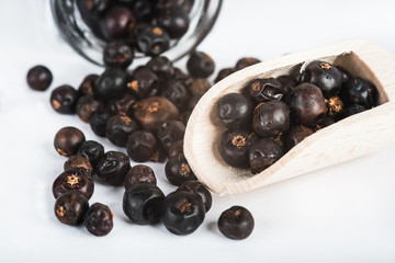 Wooden scoop with dried juniper berries