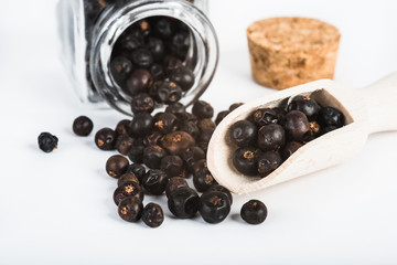 Wooden scoop with dried juniper berries