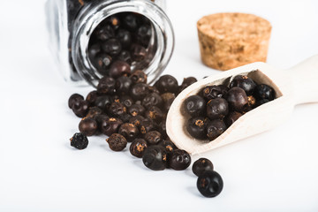 Wooden scoop with dried juniper berries